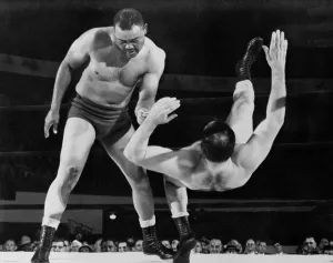 Heavyweights Prints: Joe Louis throws Jim Bernard to the mat during a 1956 wrestling match at Olympia Stadium in Detroit
