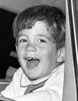 Little Boys Prints: John Kennedy Jr. smiles from the President's limousine following ceremonies on Veterans Day at Arlington National