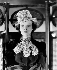 1930s Fashion Prints: Katharine Hepburn, modeling a hat and bib made of tiny flowers, 1936