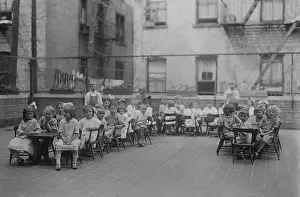 Charity Prints: Kindergarten children sit in chairs at long tables on the roof of the Lenox Hill Settlement House