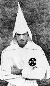 Civil Rights Prints: Ku Klux Klansman folds his arms in a traditional Klan posture at a cross burning at a small farm near Indianapolis
