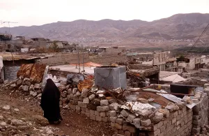Iraq Prints: Kurdish resident of Airoshky in northern Iraq walks through her destroyed town after it was bombed by Iraqi President