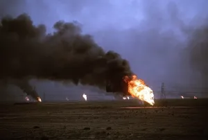 Environment Prints: Kuwaiti oil wells set on fire by retreating Iraqi forces during Operation Desert Storm darken the sky with smoke