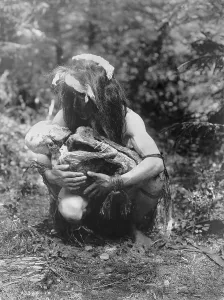 2008 Prints: Kwakiutl man, crouched, cradling mummy bound in fetal position