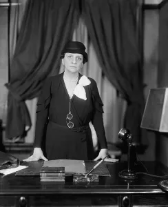 Brain Trust Prints: Labor Sec. Francis Perkins standing at her desk