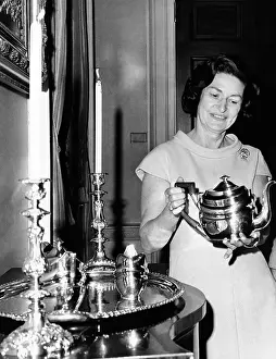 Silver Prints: Lady Bird Johnson holds a silver teapot made by Issac Hutton