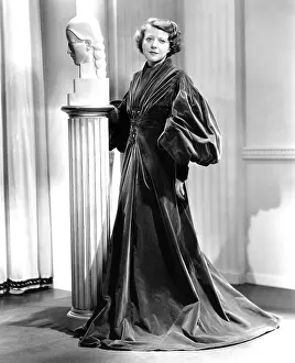 Evening Coat Prints: LADY OF SECRETS, Ruth Chatterton, in a garnet-colored cellophane-velvet evening wrap, 1936