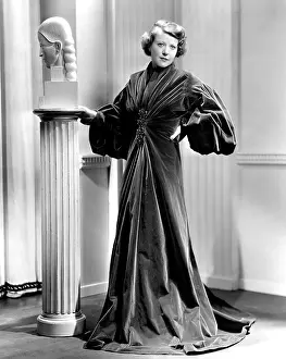 Evening Coat Prints: LADY OF SECRETS, Ruth Chatterton, in a garnet-colored cellophane-velvet evening wrap, 1936