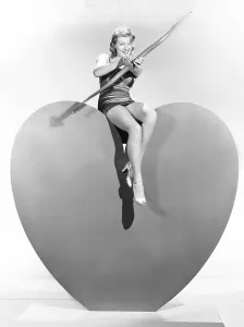 Bow And Arrow Prints: Lana Turner aims Valentine greetings, ca. 1940