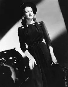 Lana Prints: Lana Turner in black ensemble featuring a short fur jacket