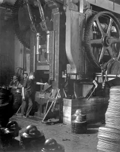 Mass Production Prints: A large power press shaped soldiers steel helmets in the of Hale & Kilburn Corp plant