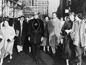 Curiosity Prints: A laughing crowd accompany a man dressed in a Martian costume crossing a street in Mid-town Manhattan on November 6