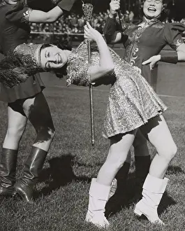 Short Skirt Prints: Lead majorette, doing a back bend while holding a baton