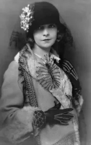 Lillian Prints: Lillian Gish (1893-1993), silent film star and wearing coat and hat with flower and long veil