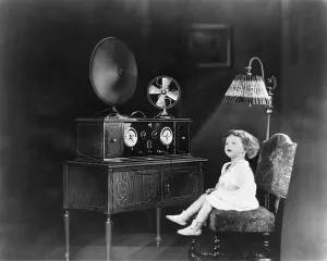 Lamps Prints: Little girl sitting on chair next to an electric powered radio