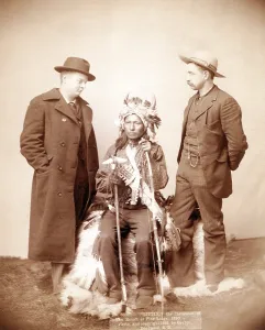 Images Dated 4th November 2008: Little, Oglala band leader, full-length studio portrait seated between two men who are standing on either side of him