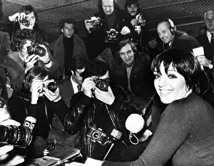 Liza Prints: Liza Minnelli is surrounded by photographers during an airport news conference in Paris