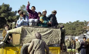 Turbans Prints: Local Afghanis ride a crowded taxi in Mazar-e Sharif a month after the Taliban were driven from their city by Northern