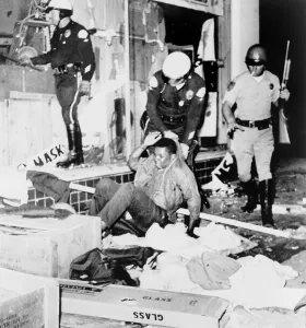 Riots Prints: Los Angeles police drag Black youth from a looted store. Aug. 13, 1965