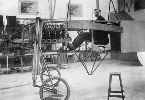 Airships Prints: Louis Bleriot 1872-1936 seated in his 50 horse power mono-plane which is under construction in his workshop