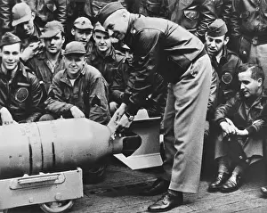 Bombs Prints: Lt. Col. Jimmy Doolittle, wires a Japanese medal to the fin of a 500 lb