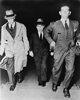 Trial Prints: Lucky Luciano (1896-1962), being escorted into court by two detectives in 1936