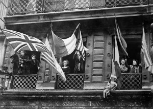 December Prints: Luxemburg women wave allied flags from their windows to greet the American Army of Occupation at the end of World War I