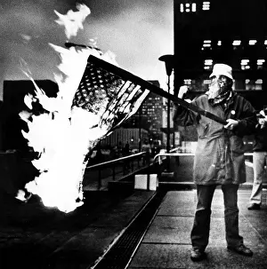 Fire Prints: A man burns an American Flag at the Federal Building at a rally in support of Iranian students holding hostages