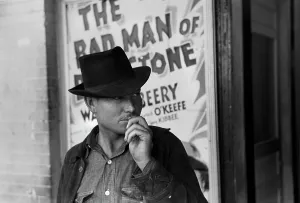 Hand On Face Prints: Man in front of a movie theater playing THE BAD MAN OF BRIMSTONE