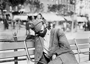 Sidewalk Prints: Man sleeping with his hat over eyes