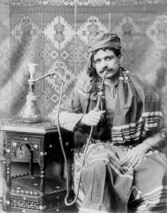 Images Dated 9th July 2008: Man smoking water pipe, photograph, 1901