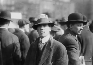 Anarchism Prints: Man wearing a Industrial Workers of the World Hat Card reading Bread or Revolution in a rally at New York City's