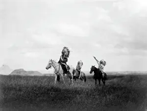 Sioux Prints: The March of the Sioux, three Sioux Indians on horseback on plains with rock formations in background