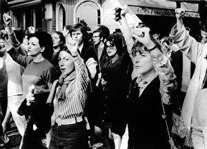 Riot Prints: MARCHES-Men & women throw their arms in the air during a march through the streets of downtown Paris for popular