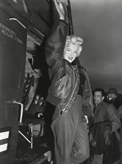 Movie Stars Prints: Marilyn Monroe arriving by helicopter at a U