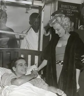 Movie Stars Prints: Marilyn Monroe visiting a wounded soldier in a hospital in Japan