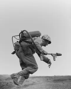 Island Prints: Marine with a flame-thrower, running to assault a Japanese pillbox on Motoyama Airfield Number Two