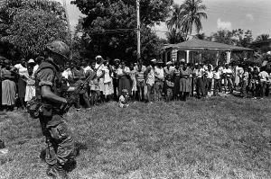 Proxy Wars Prints: Marine guards civilians after his battalion landed on Grenada during the U