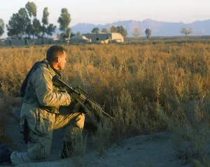 Patrol Prints: Marine Scout armed with M4 Carbine rifle provides security at a roadside south of Kandahar City during a patrol
