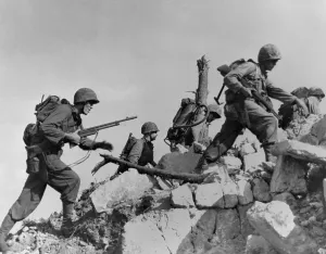 Lcgr1311 Prints: Marines hurdle a stone wall as they arrive in Okinawa