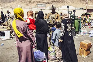 Baby Prints: US Marines process women and children Afghan evacuees at Kabul airport