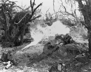 Island Prints: Marines use a flame thrower against Japanese defenses blocking advance to Iwo Jima's Mount Suribachi