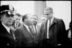 Eye Glasses Prints: Martin Luther King Jr. and Malcolm X, waiting for press conference, 1964