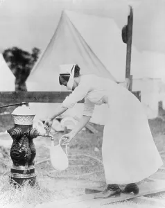 North Americans Prints: Masked nurse pumping water at a field hospital during the 1918 Spanish flu pandemic