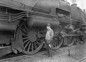 Rs3wn Prints: Mechanic servicing a railway steam engine in 1924