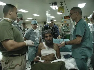 War On Terrorism Prints: Medical personnel of USS Bataan treat wounded Pashtun soldier from Afghanistan Dec