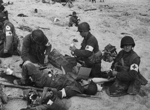Emergency Prints: Medics treat a wounded U.S. soldier on D-Day