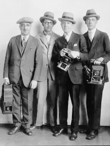 News Prints: Four members of the White House News Photographers Association, holding cameras in 1924