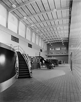 Monumental Prints: Two men at the control panel of the Chickamauga Dam are dwarfed by the large scale of the generator hall