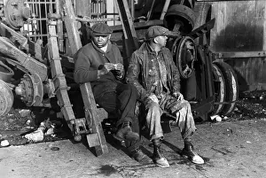 Dirty Clothes Prints: Men sitting on parts of truck in junkyard